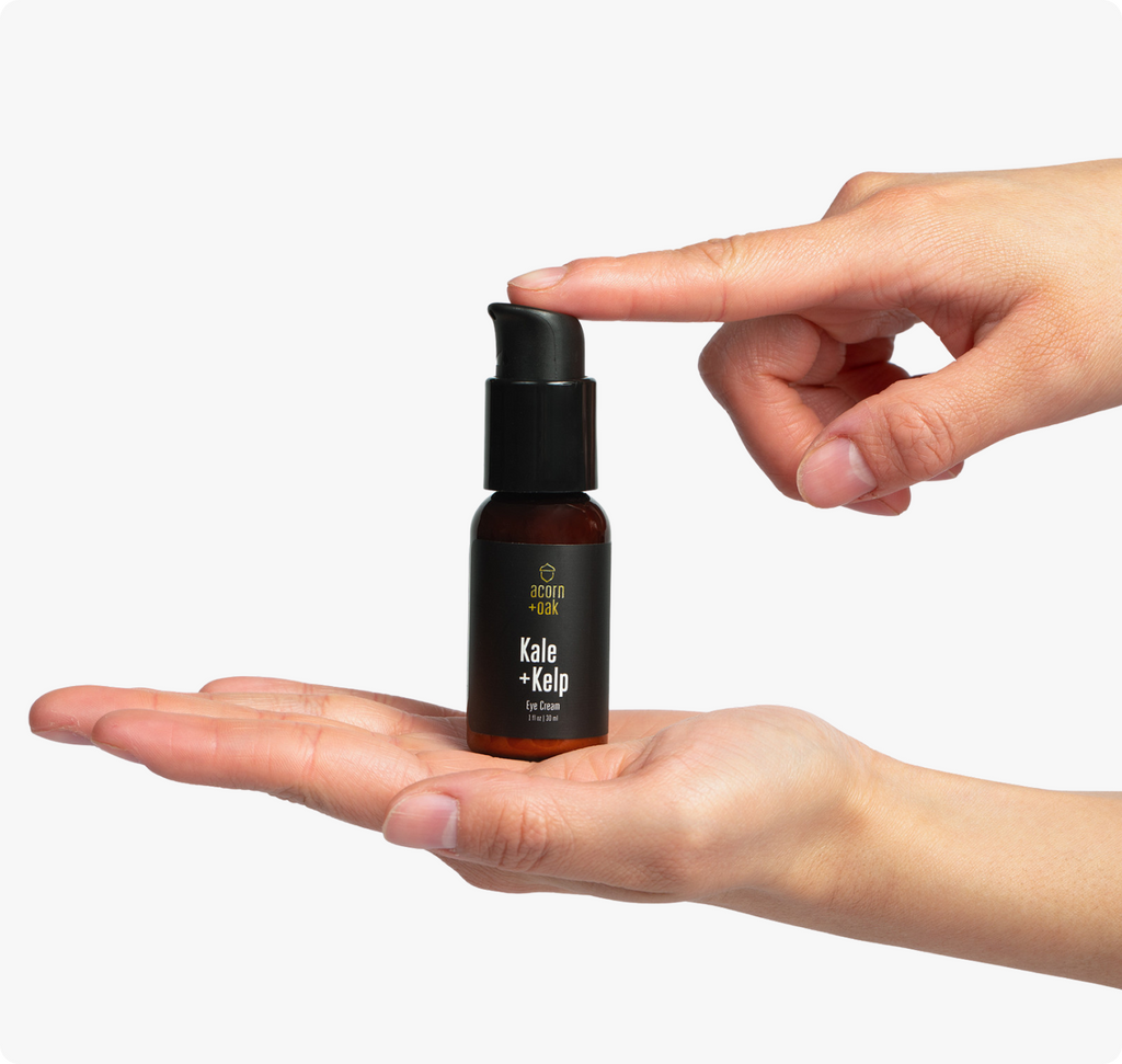 acorn+oak eye cream held in a hand against a white background
