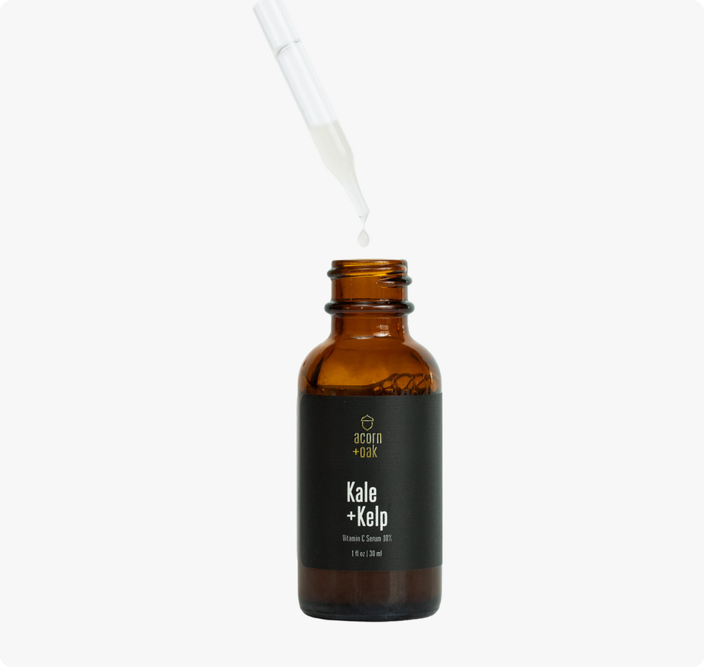 An open acorn+oak vitamin c serum with the dropper lifted up